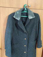 Genuine curly Astrakhan karakul fur collar on dark gray military wool coat