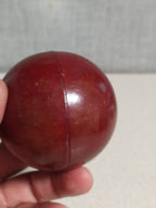 Cherry red bakelite sphere showing swirl marble pattern on one side – detail 8