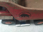 Soviet wooden toy BelAZ shown from the side with worn red paint – detail 19