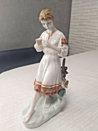 Soviet porcelain figurine of a Ukrainian girl in vyshyvanka folk costume holding a daisy