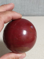 Vintage bakelite ball, deep cherry red marbled Catalin sphere with lighter red swirls