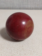 Cherry red bakelite sphere showing swirl marble pattern on one side – detail 5