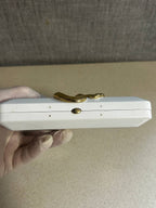Open Kilian clutch case showing black velvet lining and brand tag – detail 15