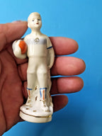 Hand-painted face and gilded boots on young Soviet soccer player figurine – detail 10