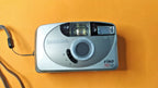 Silver Samsung 35mm film camera with built-in flash