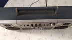Chip on the top corner of the 1980s ghetto blaster casing – detail 16