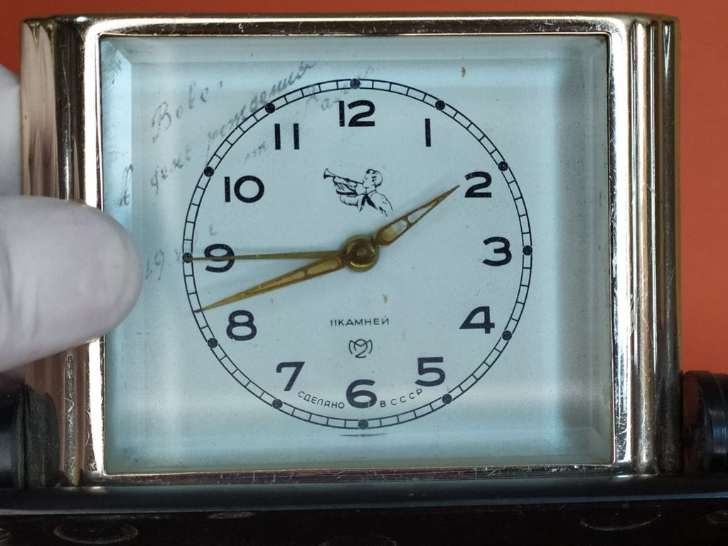 Rear controls of Slava alarm clock with wind keys and speed lever