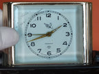 Rear controls of Slava alarm clock with wind keys and speed lever