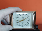 Vintage Soviet clock with tilt stand and gold-colored ribbed bezel