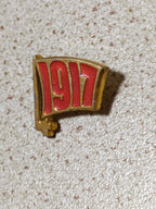 Soviet enamel pin badge with a red flag and 1917 for the October Revolution