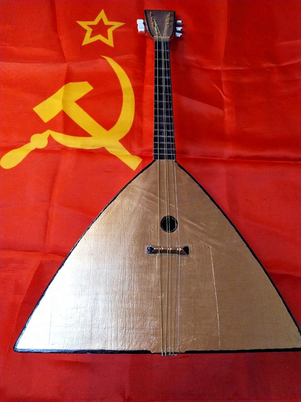 Vintage USSR balalaika with three pairs of strings and open-gear tuners