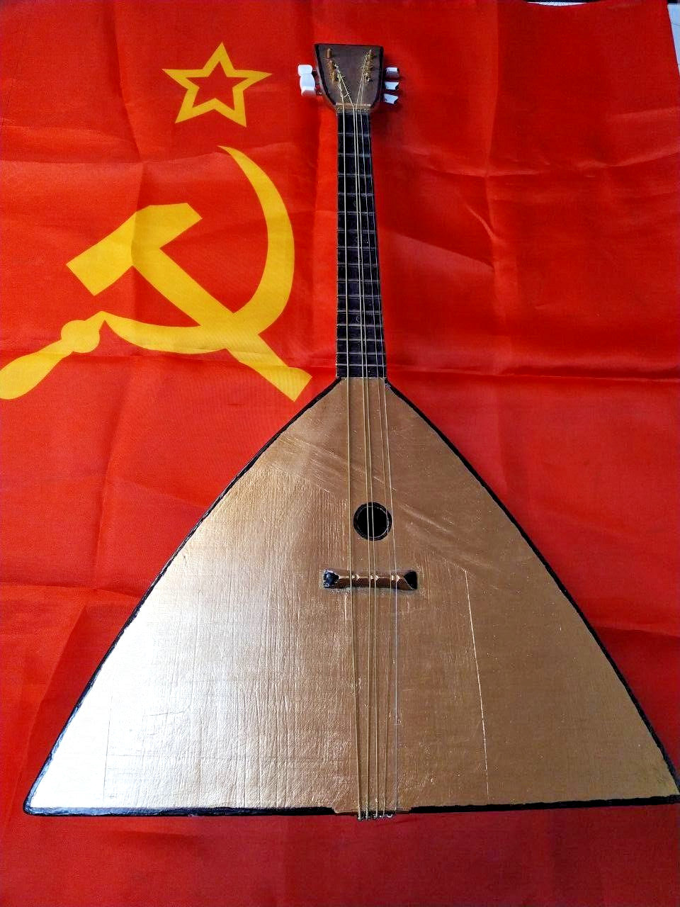 Gold-painted top and back on a Soviet folk instrument