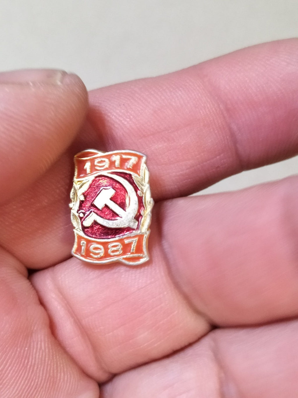 Vintage USSR 1987 anniversary badge on plain background