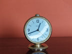Soviet alarm clock Slava 11 Jewels with white dial and gold-colored bezel on black case