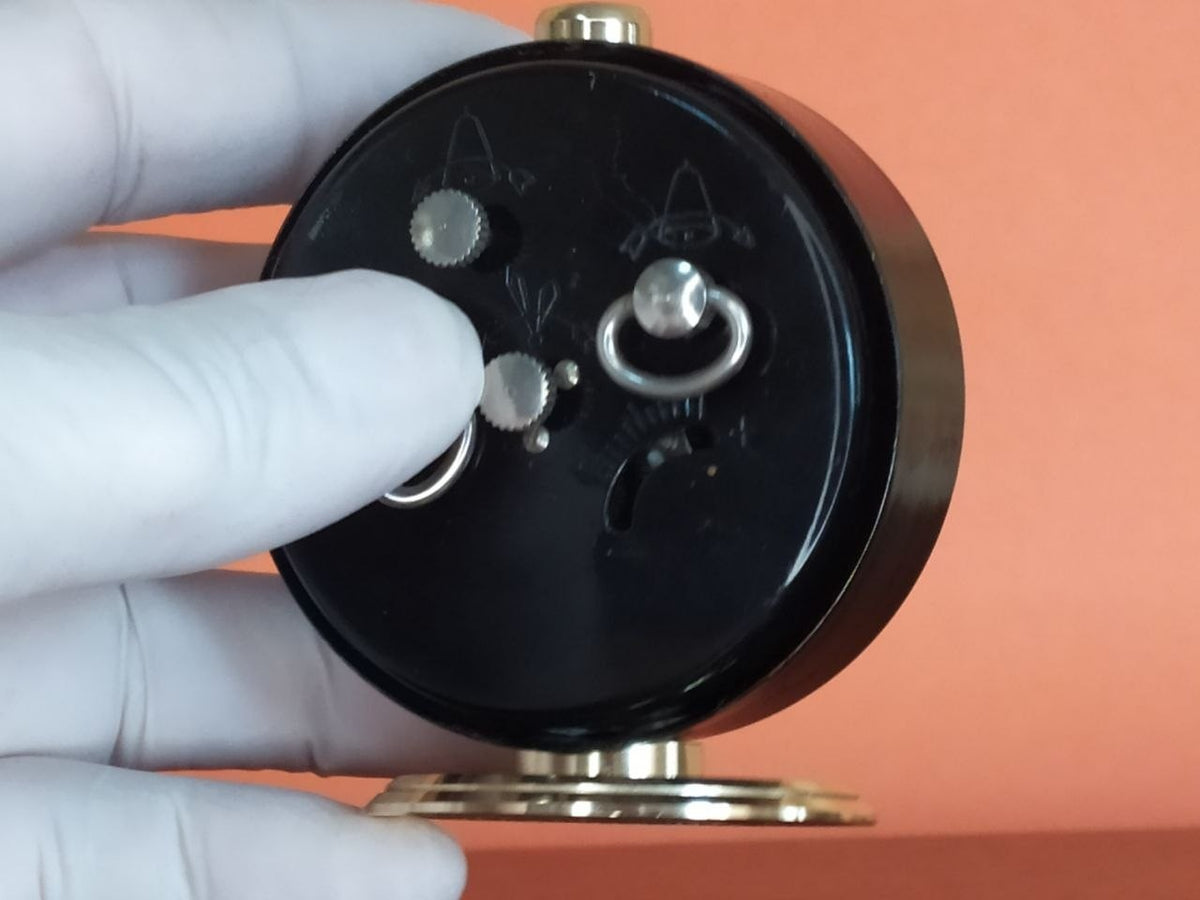 Slava alarm clock showing patina on brass parts