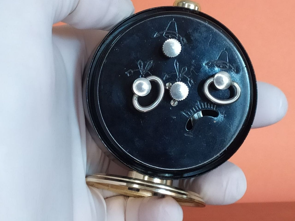 Mechanical Soviet alarm clock with gold-colored stand and matte black case – detail 6