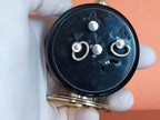 Mechanical Soviet alarm clock with gold-colored stand and matte black case – detail 6