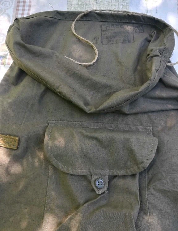 Roll-top flap and front buttoned pocket on a Soviet olive drab rucksack – detail 8