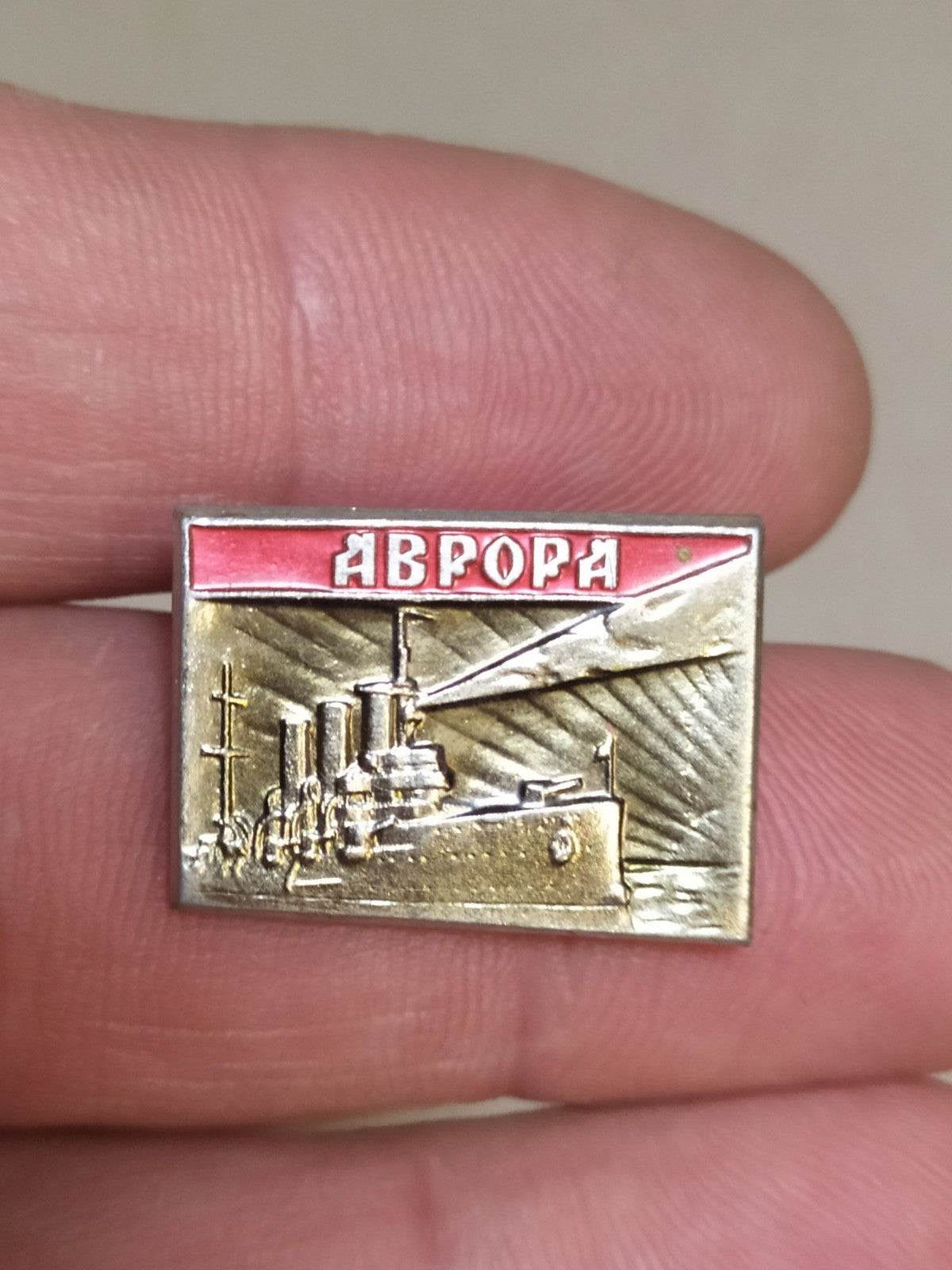 Soviet Aurora cruiser pin badge in aluminum and enamel, naval history theme