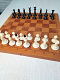 Soviet chess set with folding wooden board and weighted plastic pieces