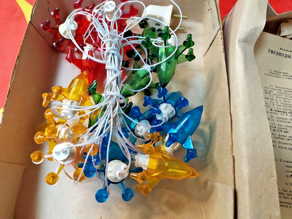 Plastic rocket light covers on the Soviet space themed holiday garland