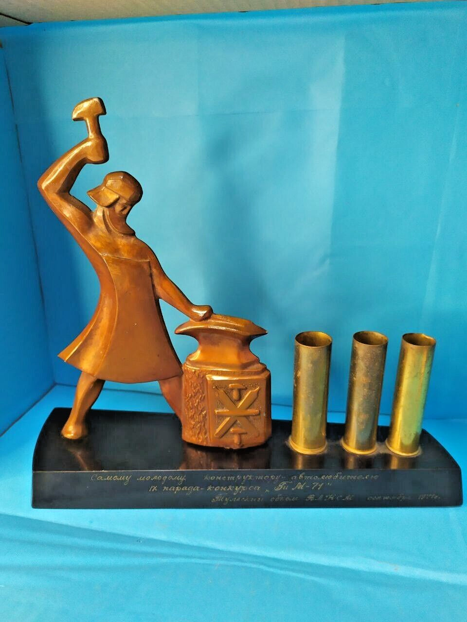 Soviet desk set pen holder with Tula blacksmith at an anvil and three brass-toned tubes
