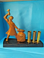 Soviet desk set pen holder with Tula blacksmith at an anvil and three brass-toned tubes