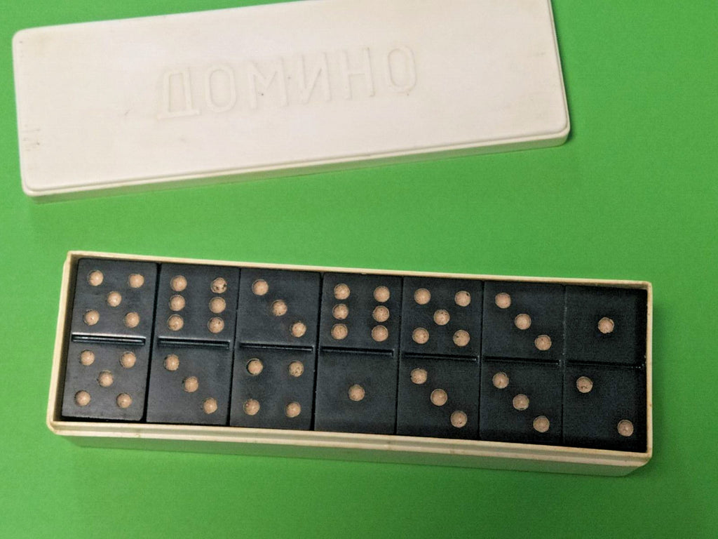Black carbolite domino tiles with cream dots and embossed rhombus pattern on the back