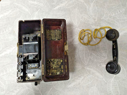 Soviet field telephone TAI-43 in dark brown Bakelite case with black handset and yellow braided cord