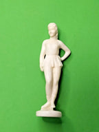 Soviet figure skater figurine in 1960s skating dress and hat, hard plastic statuette
