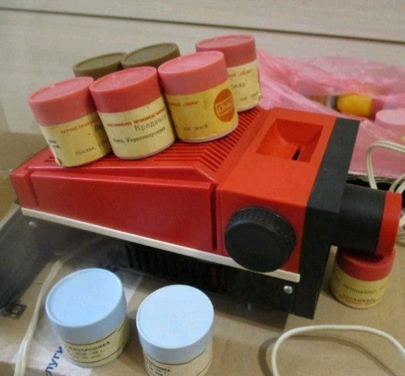 Soviet filmstrip projector Ekran in red and black plastic with 15 filmstrips