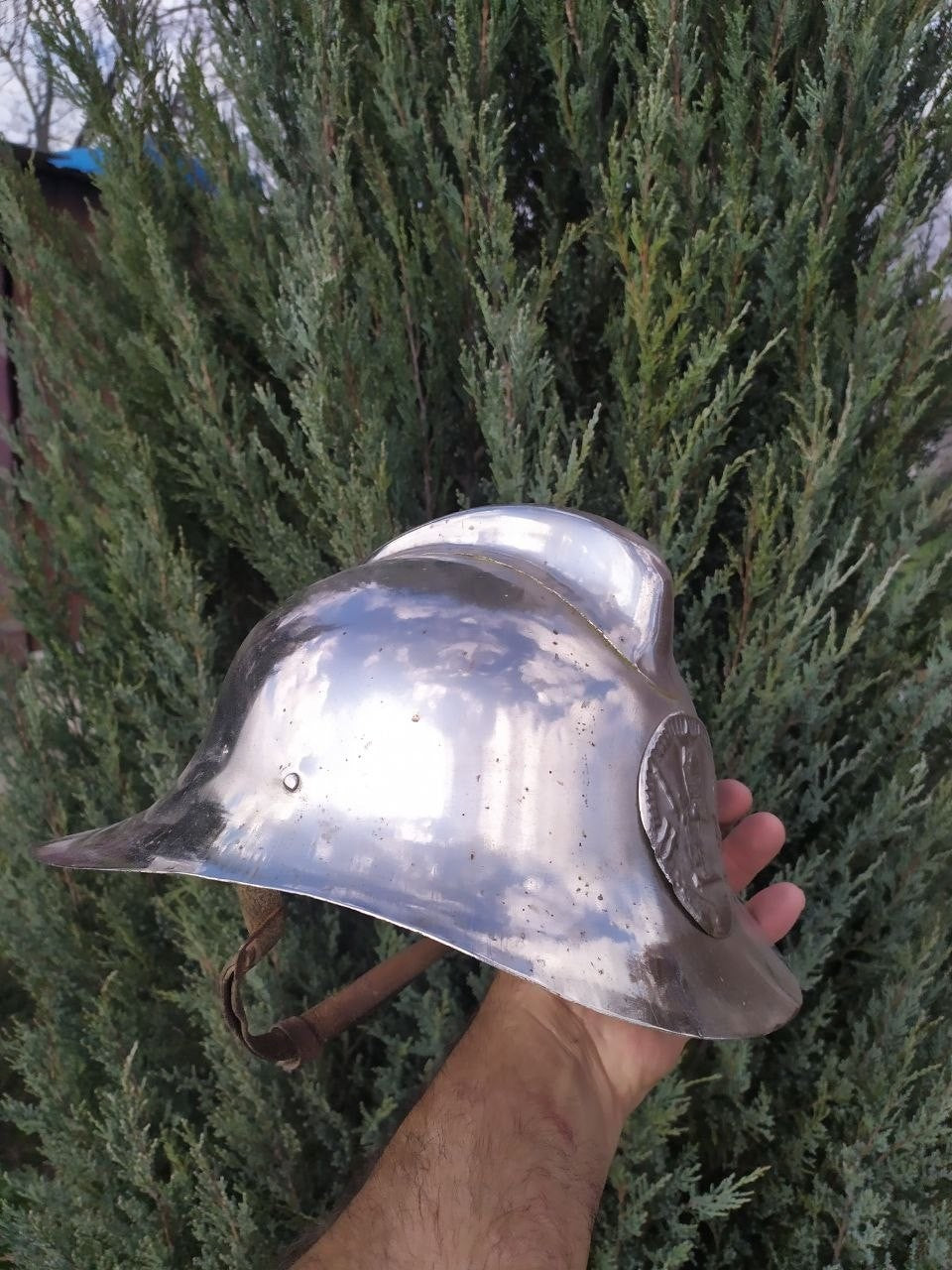 Vintage Soviet helmet for firefighters with metal insignia on the front