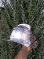 Vintage Soviet helmet for firefighters with metal insignia on the front
