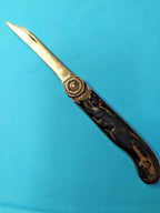 Soviet folding knife Belka with black handle and squirrel relief