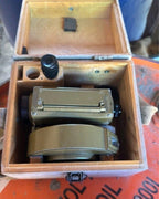 Soviet geodetic level MNP 1977 with olive hammer tone paint next to its wooden case