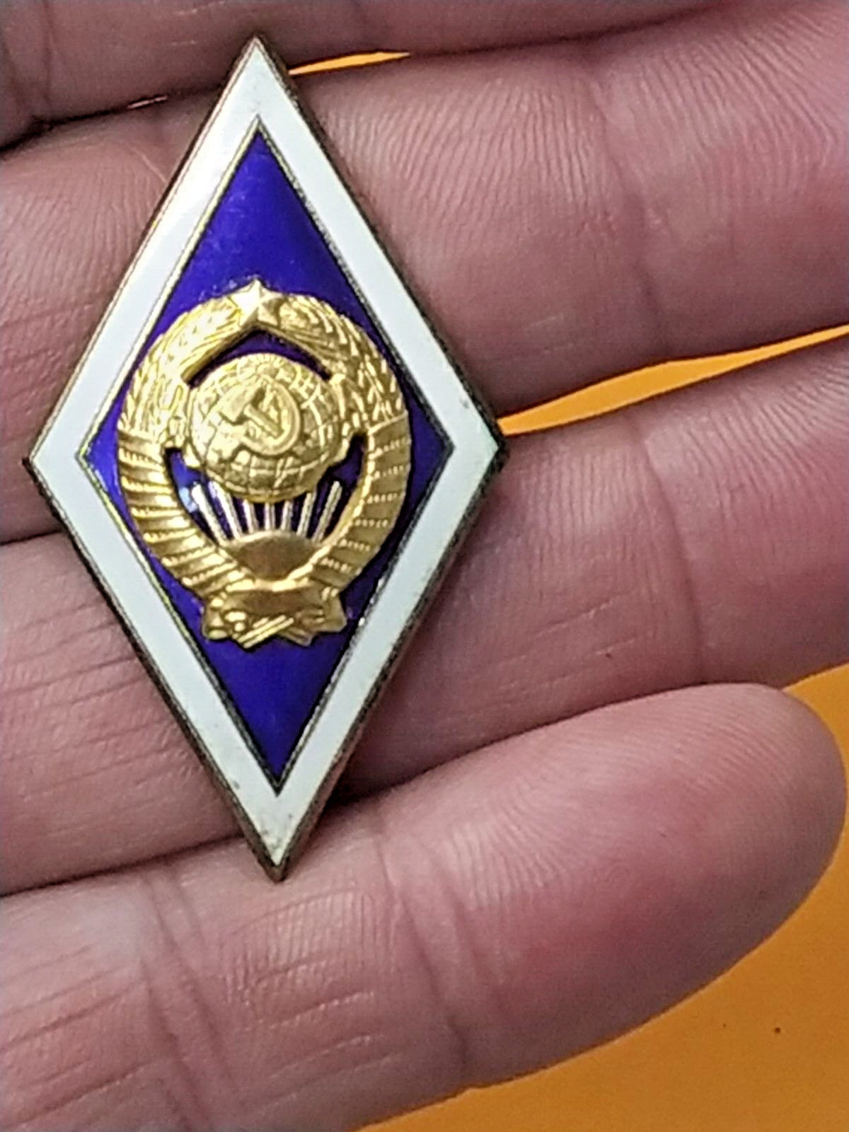 Back of Soviet badge with LMD hallmark and screw-back fastener