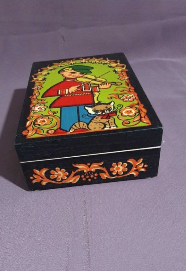 Soviet jewelry box by Bukovyna with folk art illustration of a boy playing violin beside a cat