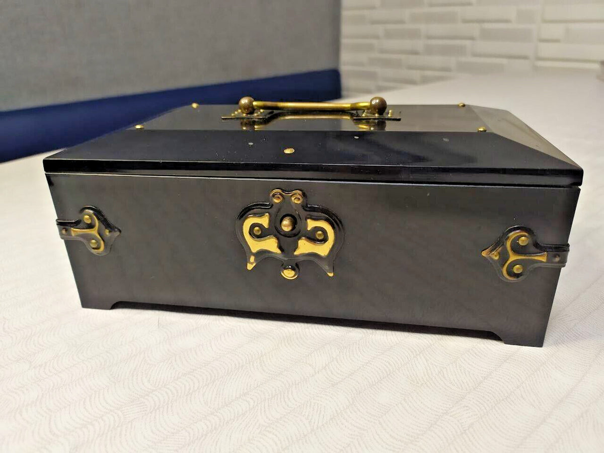 Gold-colored floral pattern under the lid of the Bakelite jewelry box