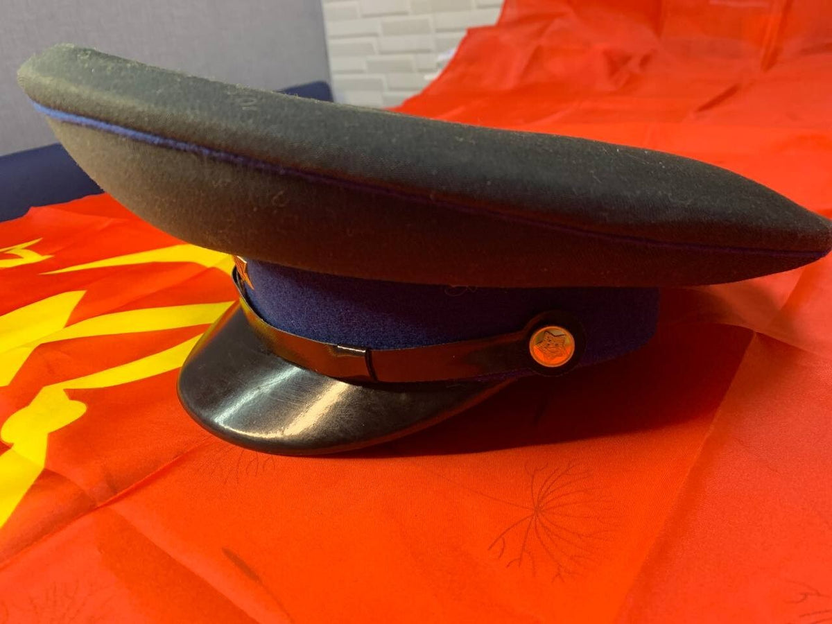 USSR military cap with black chin strap and brass-colored buttons