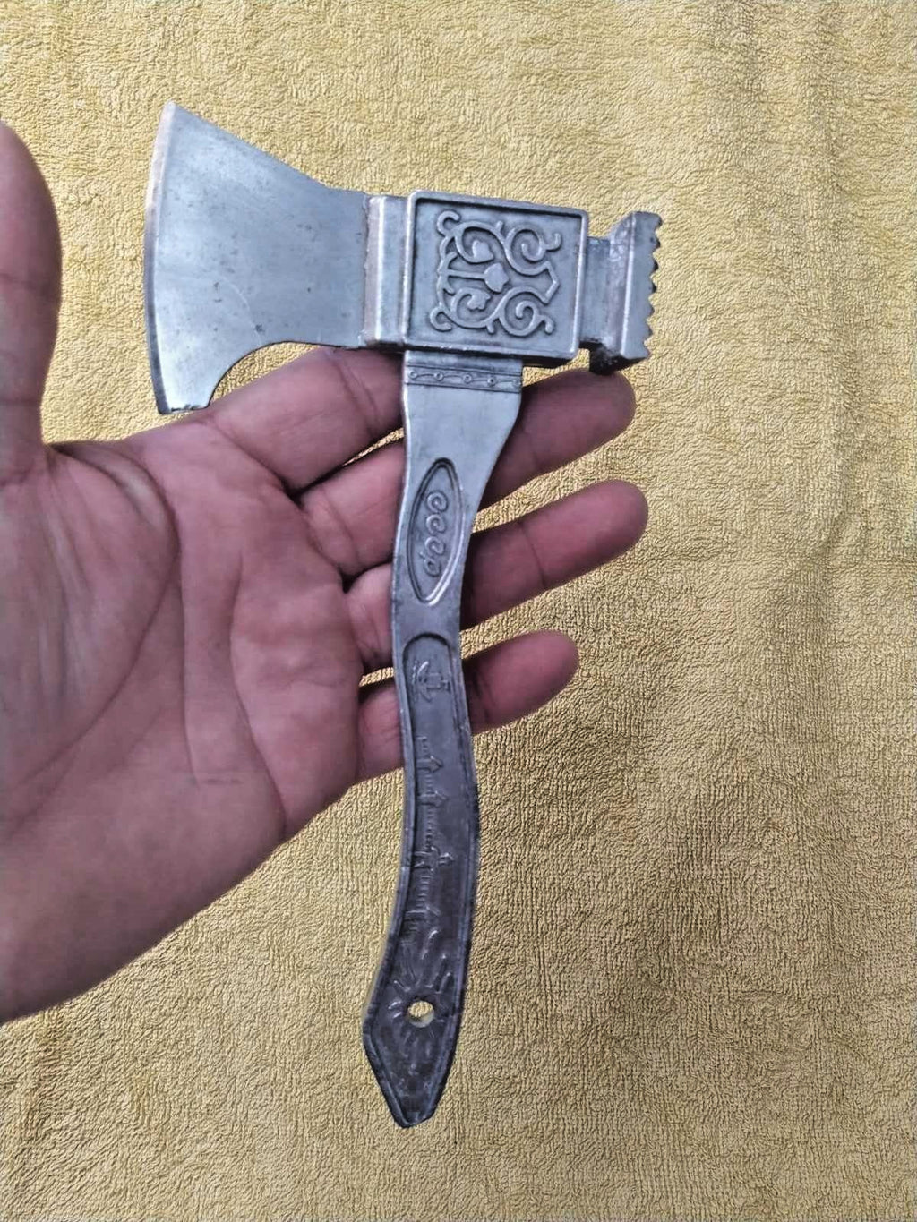 Cast handle with stylized kremlin wall relief