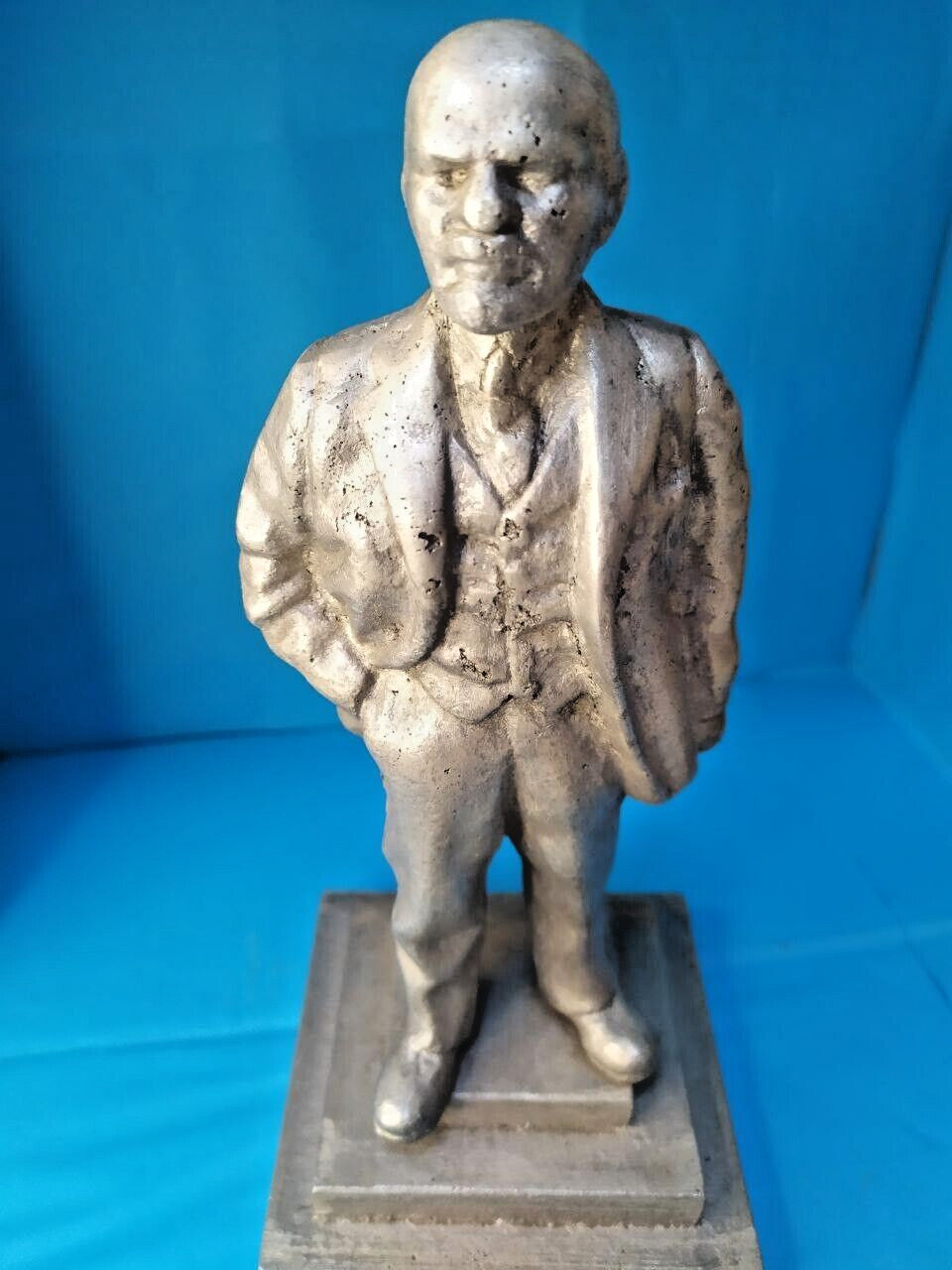 Lenin statue in suit and vest, thoughtful pose, side view