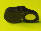 Folding pocket magnifier opened with clear glass lens swung out