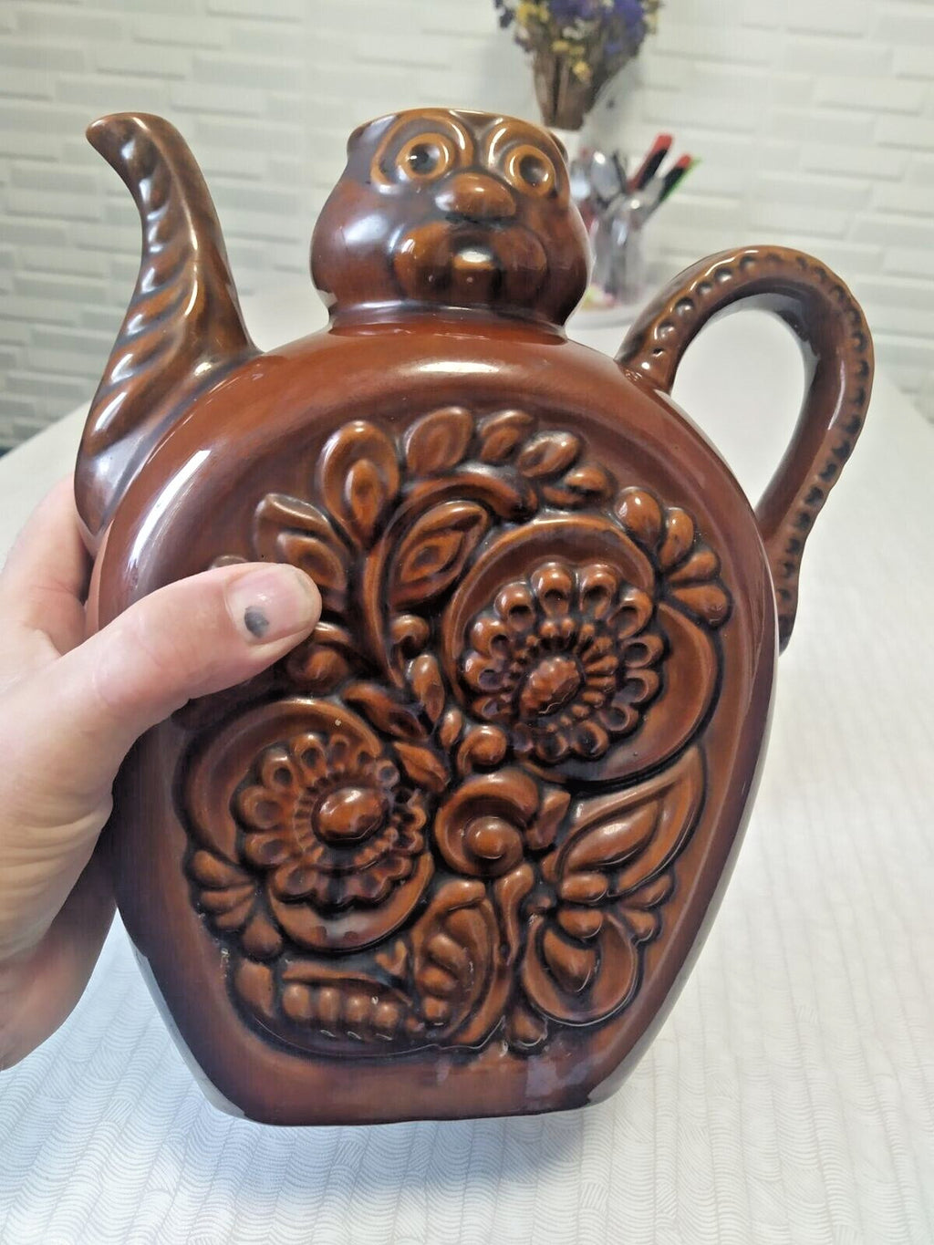 Anthropomorphic kumanets jug with stylized face and curved spout