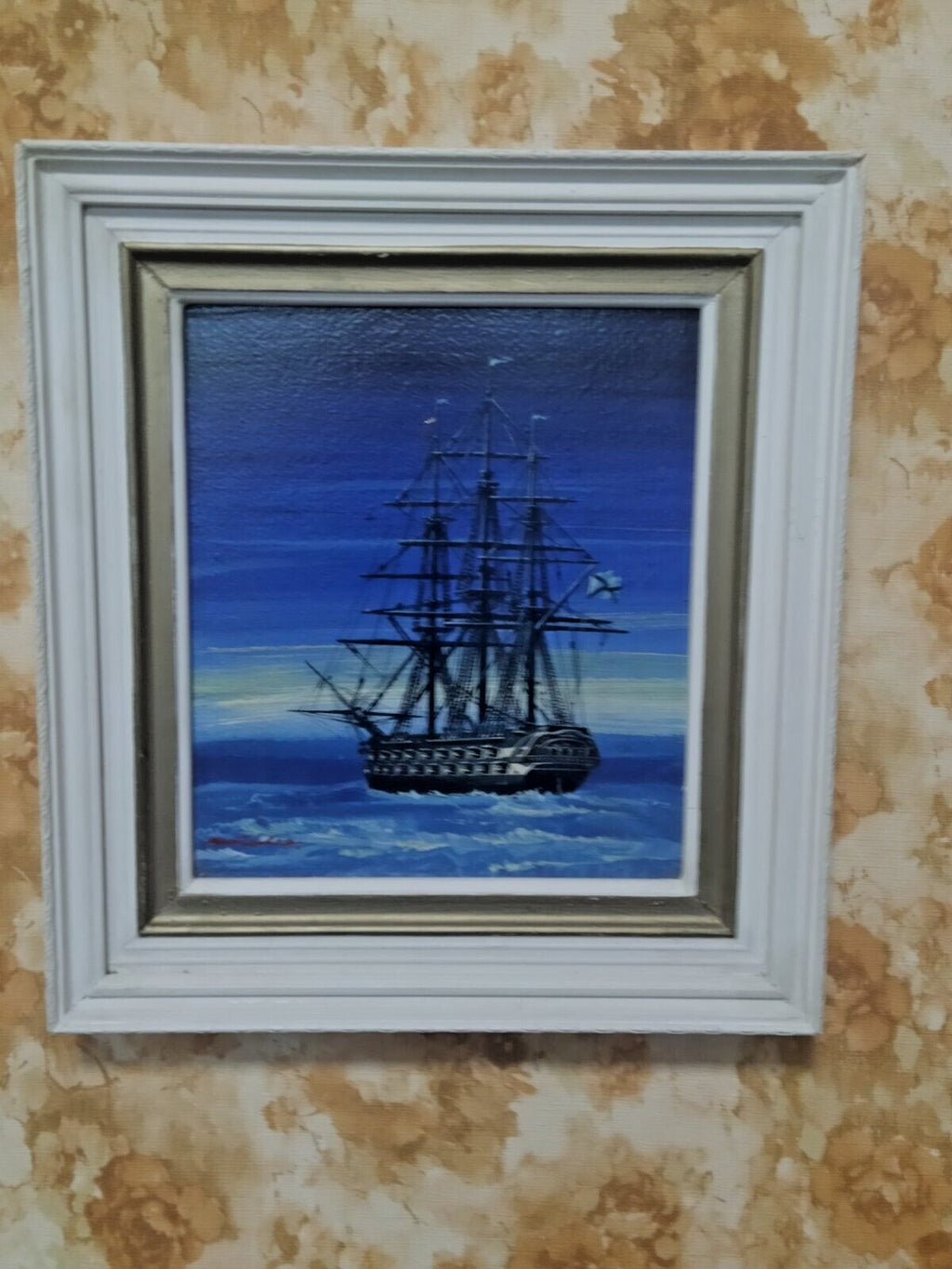 Tall ship painting in white wooden frame with gold inner rim