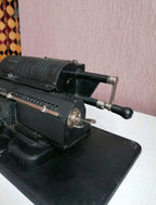 Levers, carriage and black textured paint of a Soviet arithmometer