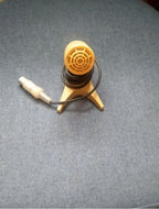 Light beige MD-200 microphone on its three-legged plastic stand