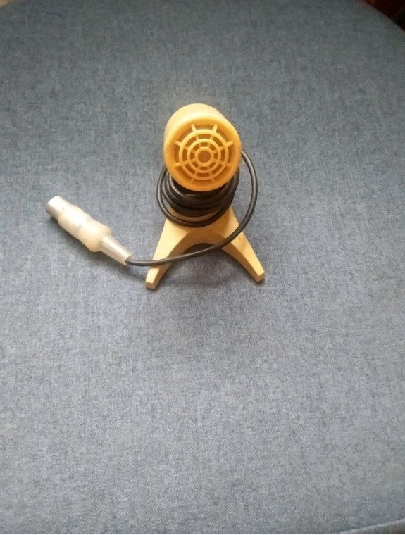 Light beige MD-200 microphone on its three-legged plastic stand