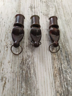 Soviet militaria set of 3 dark brown carbolite signal whistles with split rings