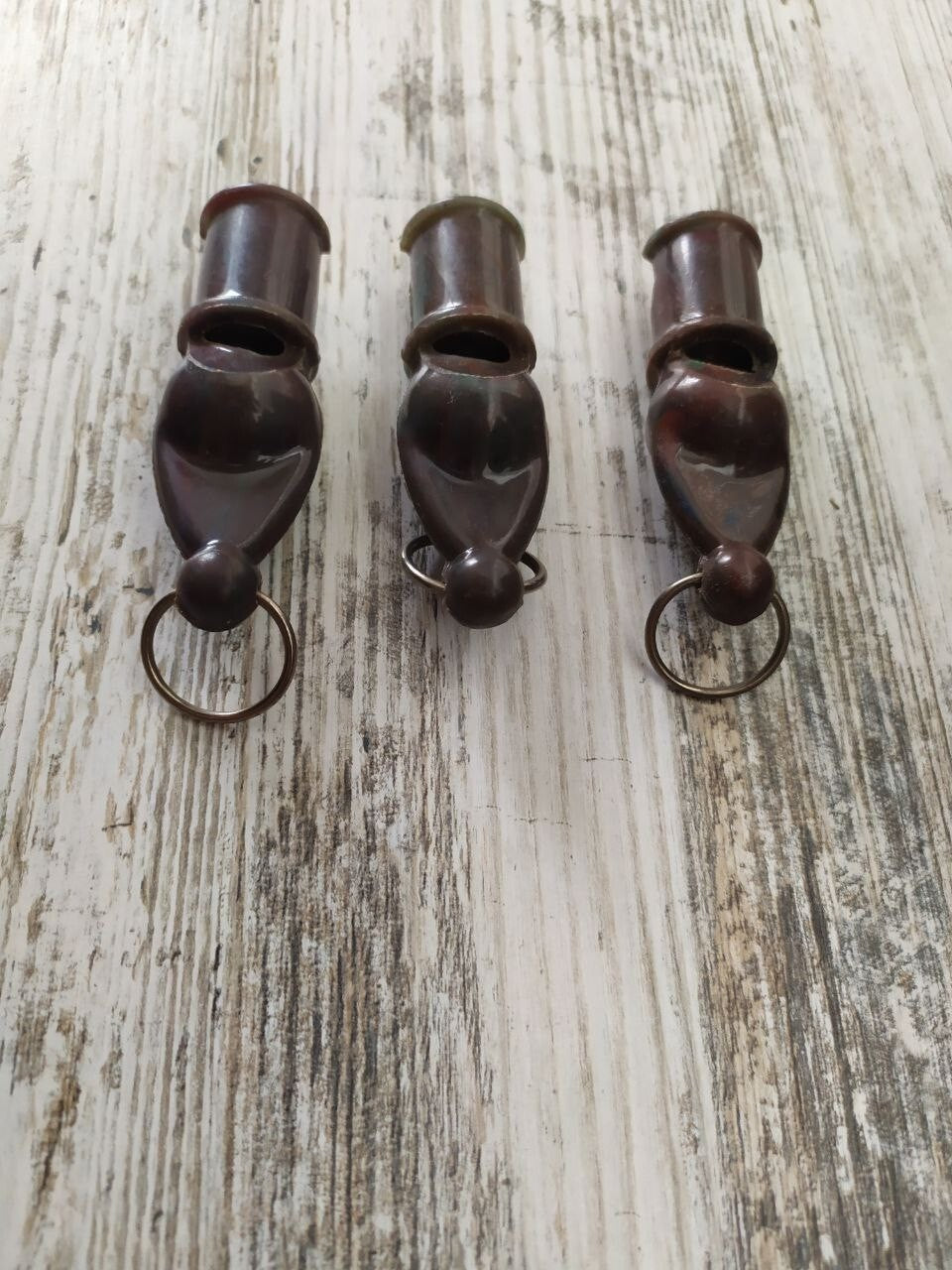 Soviet militaria set of 3 dark brown carbolite signal whistles with split rings