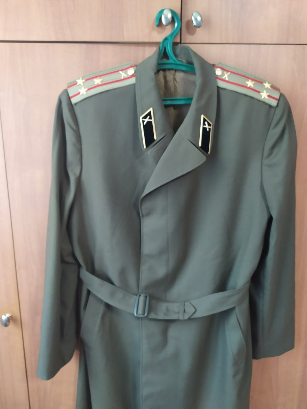 Gold crossed cannons on black velvet collar of the Soviet army uniform coat